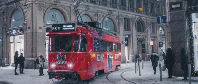 How You Can Study In Finland Tuition-Free This Year. Red tram on snowy night in Helsinki.