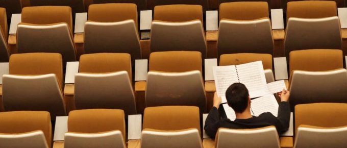 Student sitting in Empty class. How You Can Study Abroad Without IELTS