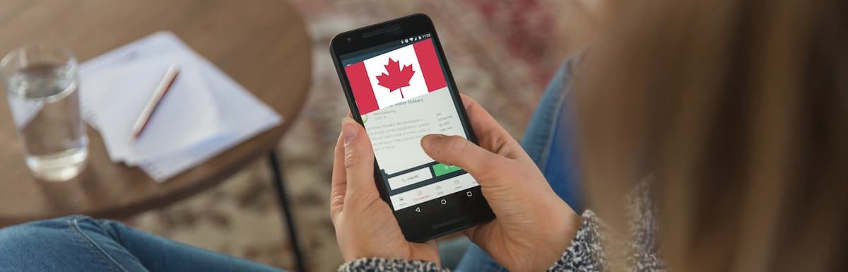 A female student searching for universities in Canada on a smartphone. How to Find and Apply to a Cheap University in Canada.