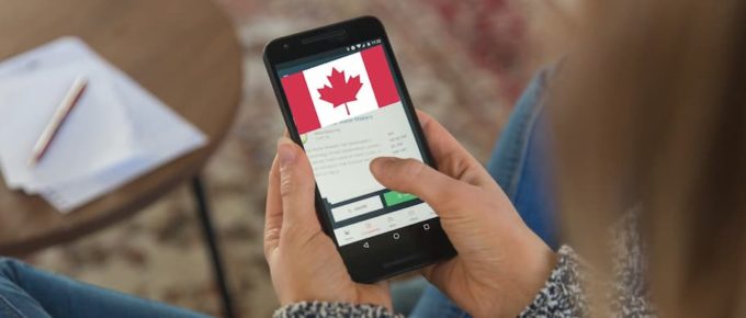 A female student searching for universities in Canada on a smartphone. How to Find and Apply to a Cheap University in Canada.