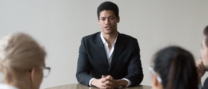 Young male professional in an interview with employers. Top 3 Best Countries to Land a Job After Graduation.